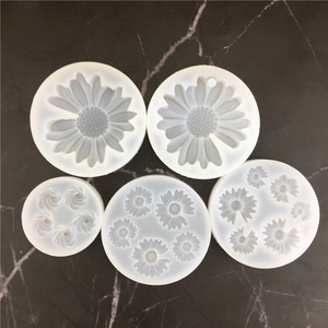Top view of five translucent silicone molds for various sizes of daisy flower shapes
