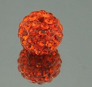 Macro shot of 8mm orange crystal-studded clay disco ball bead with sparkling reflection