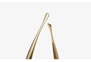 Macro shot of precise golden metal tips with mirror-like polished finish and fine craftsmanship