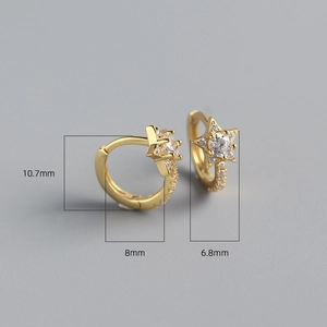 Detail view of gold star earrings with cubic zirconia and exact size specifications