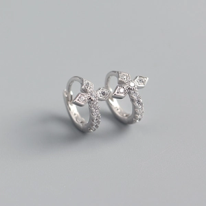 Macro shot of silver cross earrings encrusted with sparkling clear cubic zirconia