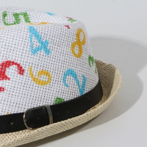 Detail of white straw hat with colorful embroidered numbers and black faux leather belt