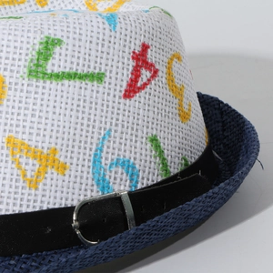 Detail of child's straw hat with colorful letter embroidery and navy blue brim