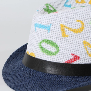 Macro detail of kids straw hat featuring mesh crown with colorful letters and navy brim