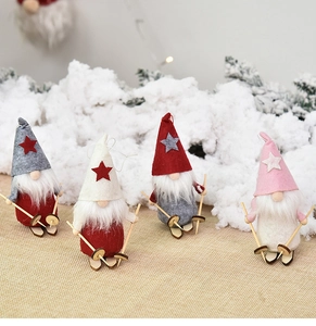 Close-up of four plush Christmas gnomes with wooden skis and sticks on snowy fabric