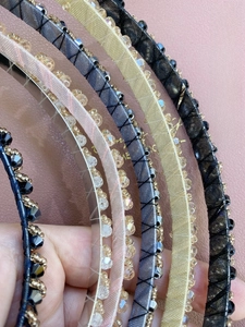 Close-up of handmade beaded headbands with colorful crystal beads and ribbon wrapping
