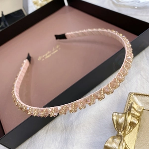 Detailed macro view of handmade champagne crystal beaded headband in a gift box