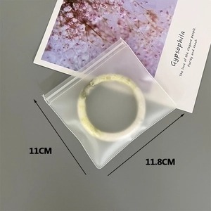 Close-up of translucent frosted EVA jewelry bag with zipper lock for bracelet storage