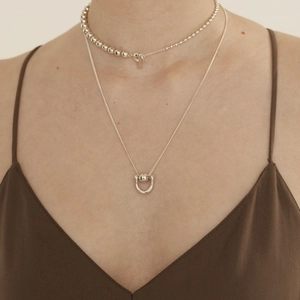 Layered 925 sterling silver necklaces with geometric beads and U-shaped pendant