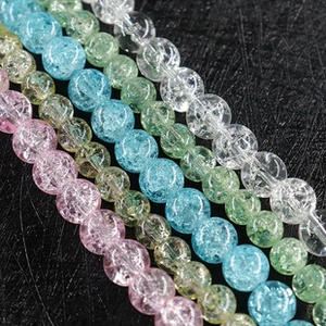 Macro detail of colorful cracked agate round beads in pink yellow blue and green
