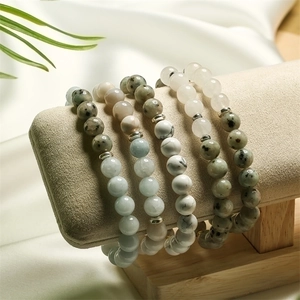 Macro view of natural stone beaded bracelets in assorted colors on a jewelry stand