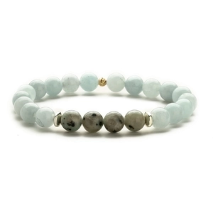 Natural labradorite and turquoise beaded bracelet with gold faceted charm on white background