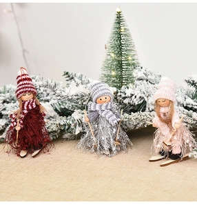 Detailed view of knitted skiing gnome dolls with wooden skis for Christmas tree decor