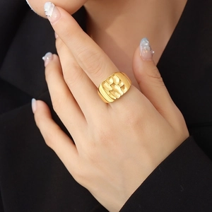 French style gold wide band ring with irregular hammered texture on female index finger