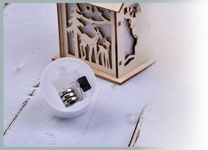 Detail of wooden Christmas light house showing battery compartment with 3 LR1130 cells