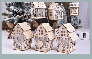 Detail of wooden glowing Christmas houses with laser-cut reindeer and snowflake patterns