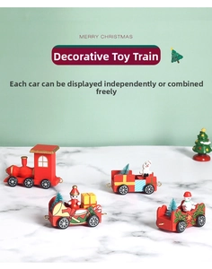 Macro shot of red wooden Christmas train with snowman and tree on marble surface