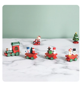 Macro view of Christmas wooden train with Santa and snowman on white marble tabletop