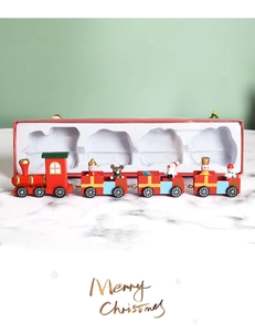 Detailed view of a festive wooden Christmas train set with a red holiday gift box