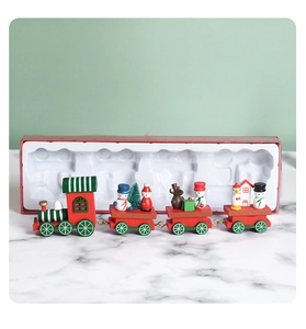 Detail view of a red and green wooden Christmas train with miniature holiday figurines