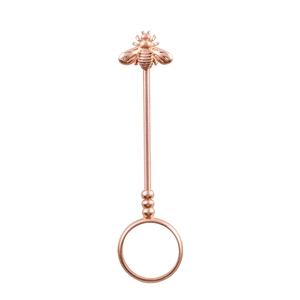 Macro shot of rose gold cigarette holder ring featuring detailed 3D bee decorative top