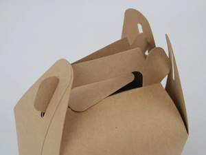 Close-up of brown kraft paper box handle and buckle structure for secure packaging