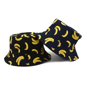 Black and navy blue bucket hats with yellow banana print for summer sun protection