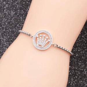 Detail of silver crown pendant bracelet with rhinestones worn on wrist