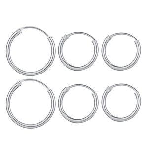 Three sets of polished stainless steel hoop earrings in varied sizes on a white background