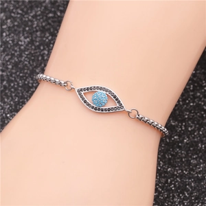 Macro detail of silver evil eye bracelet with turquoise stone and black zircon setting