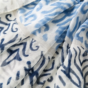 Detail of bohemian wavy print on lightweight cotton-linen scarf with fringed edges