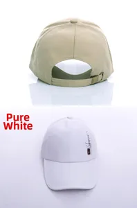 Detail view of khaki and white cotton baseball caps with adjustable metal buckles and print
