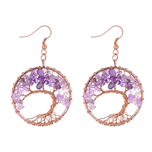 Macro detail of handmade wire-wrapped tree of life earrings with purple crystal stones