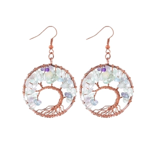 Close-up of handmade tree of life earrings with colorful natural crystal stones