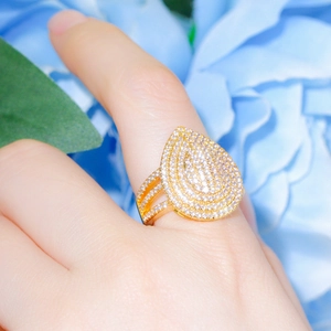 Elegant gold pear cut teardrop ring featuring micro-pave cubic zirconia on a split band