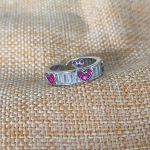 Detail of silver open ring with pink heart gems and rectangular clear crystals