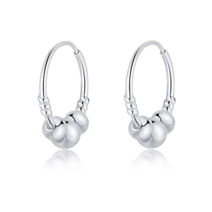 Macro shot of silver S999 hoop earrings with three polished round beads on white backdrop