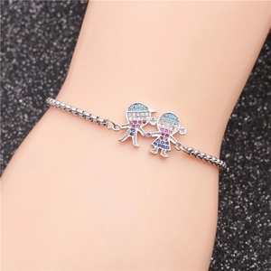 Detail of evil eye chain bracelet featuring boy and girl pendant with colorful zircon stones