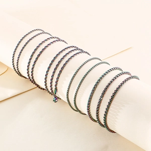 Iridescent stainless steel rope and box chains wrapped on a cylinder display