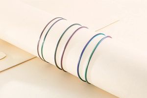 Macro detail of rainbow plated stainless steel snake chains on a display stand