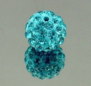 Macro shot of a blue crystal disco ball bead with rhinestones for jewelry making