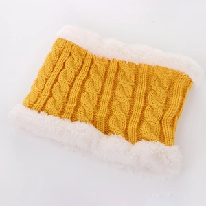 Close-up of a bright yellow knitted baby neck warmer with thick white faux fur lining texture