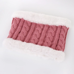 Close-up of pink knit scarf with white faux fur lining and thick winter texture