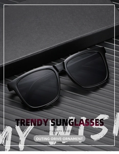 Detail view of stylish black square frame sunglasses on a textured display stand