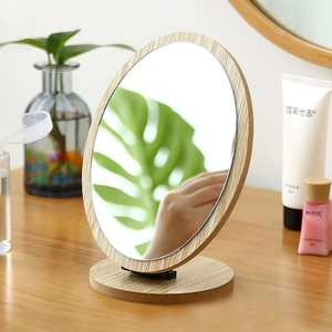Minimalist round wooden desktop makeup mirror with a natural wood grain finish and base