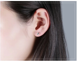 Minimalist S999 sterling silver ball stud earring shown on ear for a delicate look