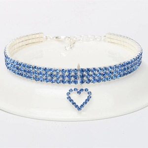 Three-row rhinestone pet choker with heart pendant on a white platform stand