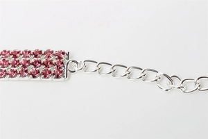 Detail of pink triple-row rhinestone pet collar with silver plated metal chain links