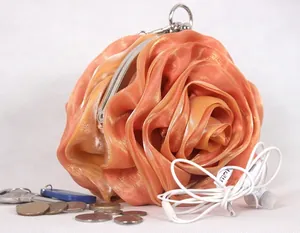 Peach silk rose clutch bag with metallic frame closure and 3D floral petals design
