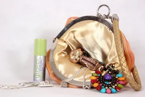 Orange silk satin evening bag with golden metal frame and champagne woven handle